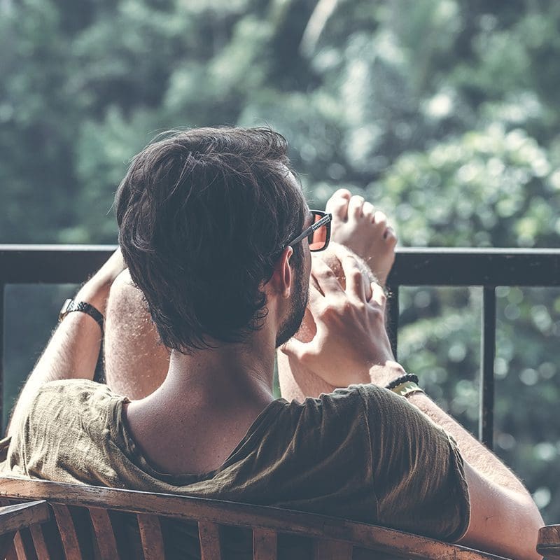 man relaxing on back porch man relaxing on back porch